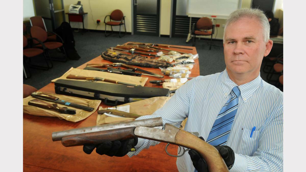 Tasmanian gun owners are arming themselves with more registered firearms than ever before. Detective Inspector Scott Flude with firearms seized by police. 