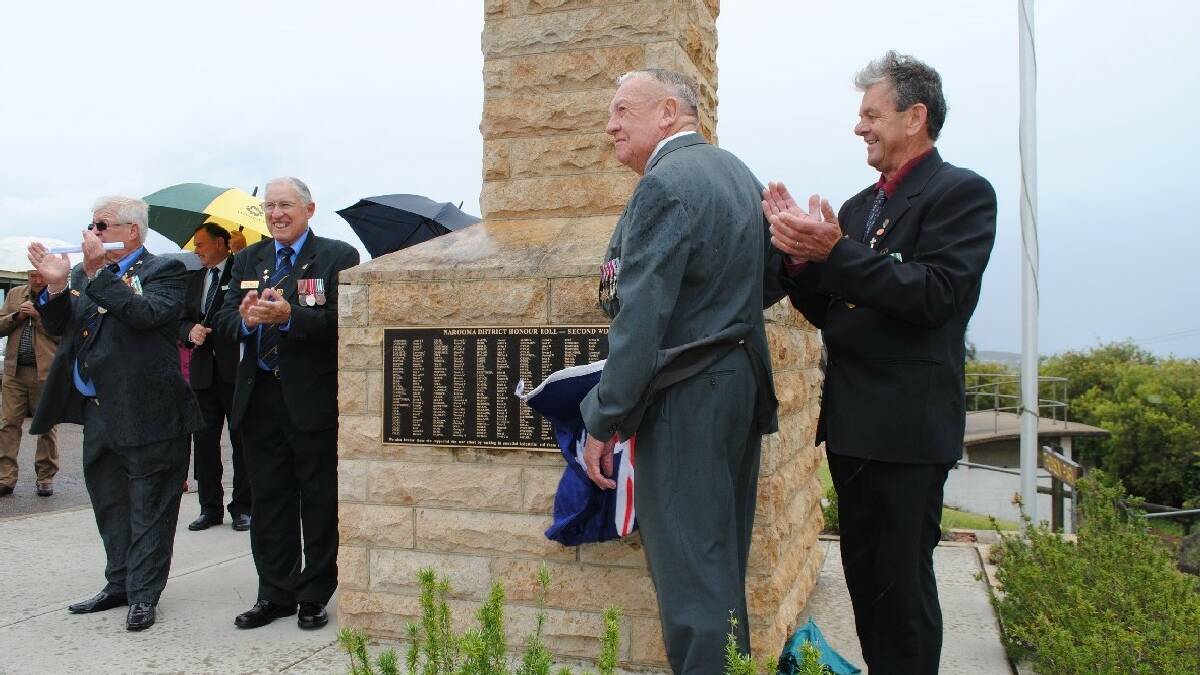 NAROOMA: Jim Pollock (centre) unveils the new plaque dedicated to the veterans from WWII that come from the local area. He is watched by Narooma RSL sub branch   president, Paul Naylor (left), Jon King and Trevor Bennett (right).