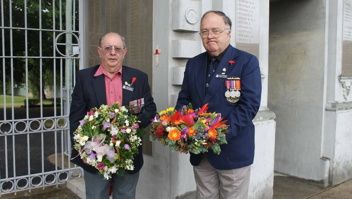 BEGA: Bill Flood and Ken Witchard of the Bega RSL sub-branch lay wreaths at the Bega War Memorial Gates following a Remembrance Day ceremony held indoors   at Club Bega.