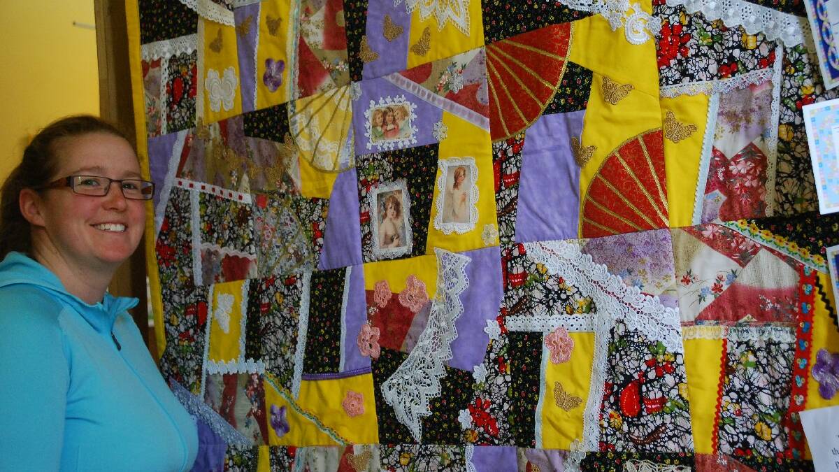  ADAMINABY: Sarah Forsdyke of Berridale admires the winning Crazy Quilt made of recycled materials by 11-year-old Emma-Kate Nicholson on   display at the Adaminaby Quilt Show. Some of the hand crocheted pieces were more than 90-years-old.
