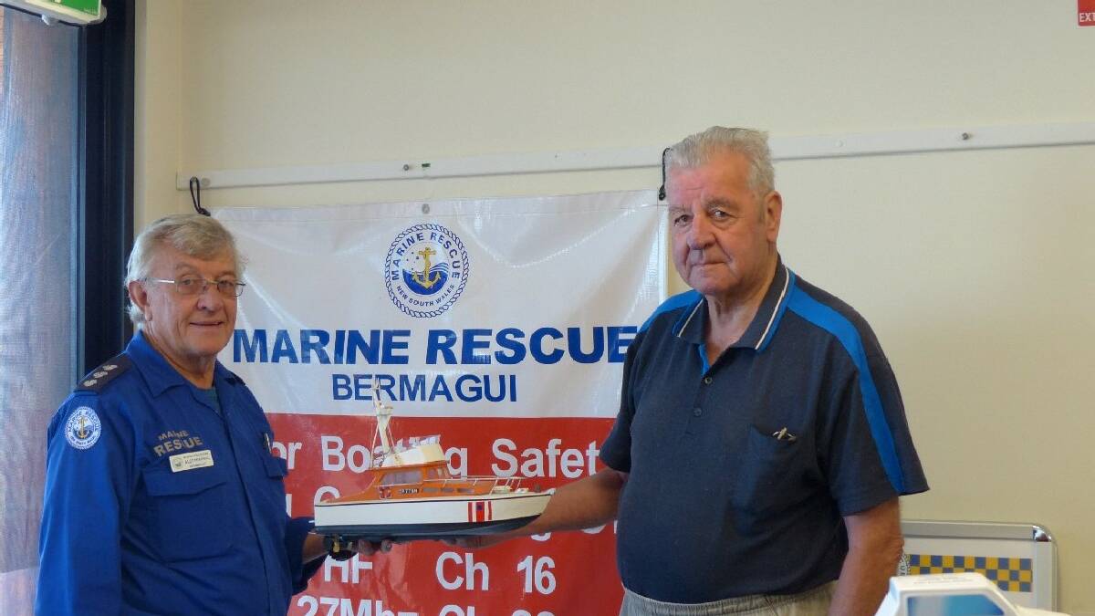 BERMAGUI: Bermagui Marine Rescue commander Alec Percival thanks Keith Driver for his donation of the model boat of former rescue boat James T. Lees that will take   pride ofplace in the radio room HQ.  
