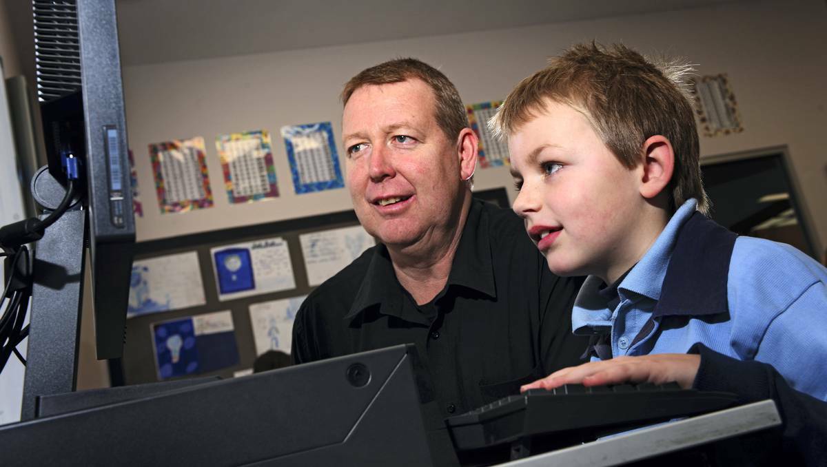 Perth Primary School pupils will be among the first in the nation to trial National Assessment Program Literacy and Numeracy (NAPLAN) testing online. Pictured is Perth Primary School grade 3 teacher Chris Wheeler and pupil Jacob Widdowson.