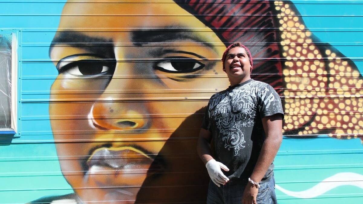 NAROOMA: Local Koori youth Warren Foster Jnr with his likeness painted in the side of “Patty” the medical outreach van. Graffiti artist Ash Johnston came to   Katungul Aboriginal health service to help teach local young peer educators the “Your Mob, My Mob, Our Mob” program.