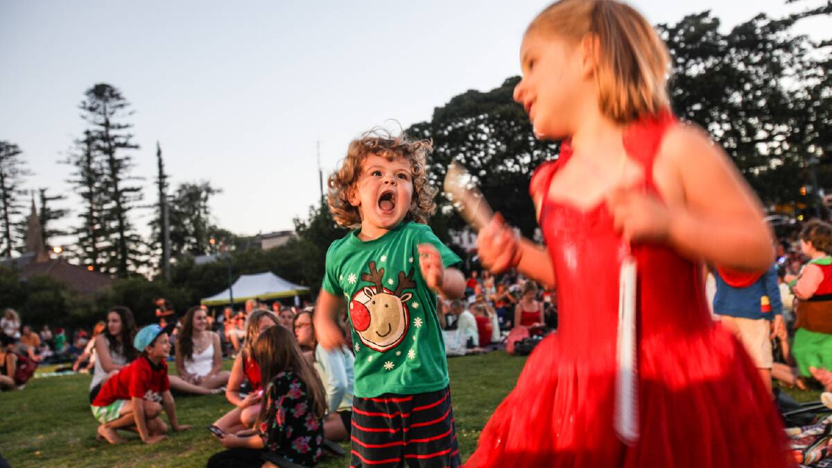 Carols in the Park. Aiden Strong, 3, and Violet Fonge, 7, dance and sing to Christmas Carols. Picture: DYLAN ROBINSON