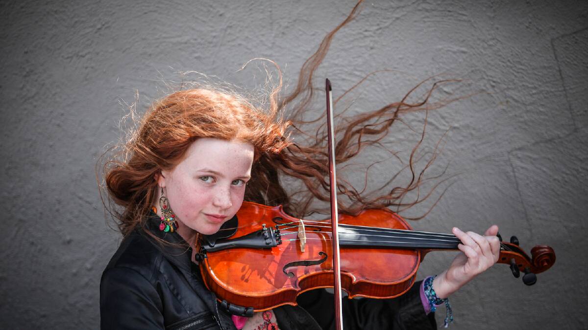 Claire Doherty, 11, playing her violin on the stairs at Folk by the Sea in Kiama. Picture: DYLAN ROBINSON