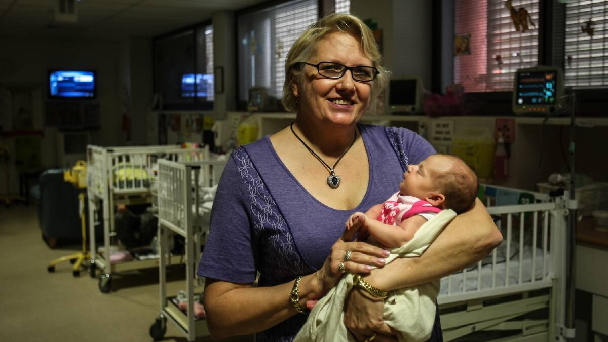 Yvonne Medina from Albion Park, holding two-week-old Ava Thormann, won the Midwife of the Year Award. Picture: DYLAN ROBINSON