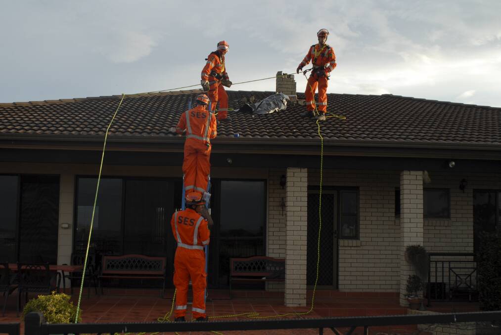 NSW SES Kiama unit work on the house hit by lightning.