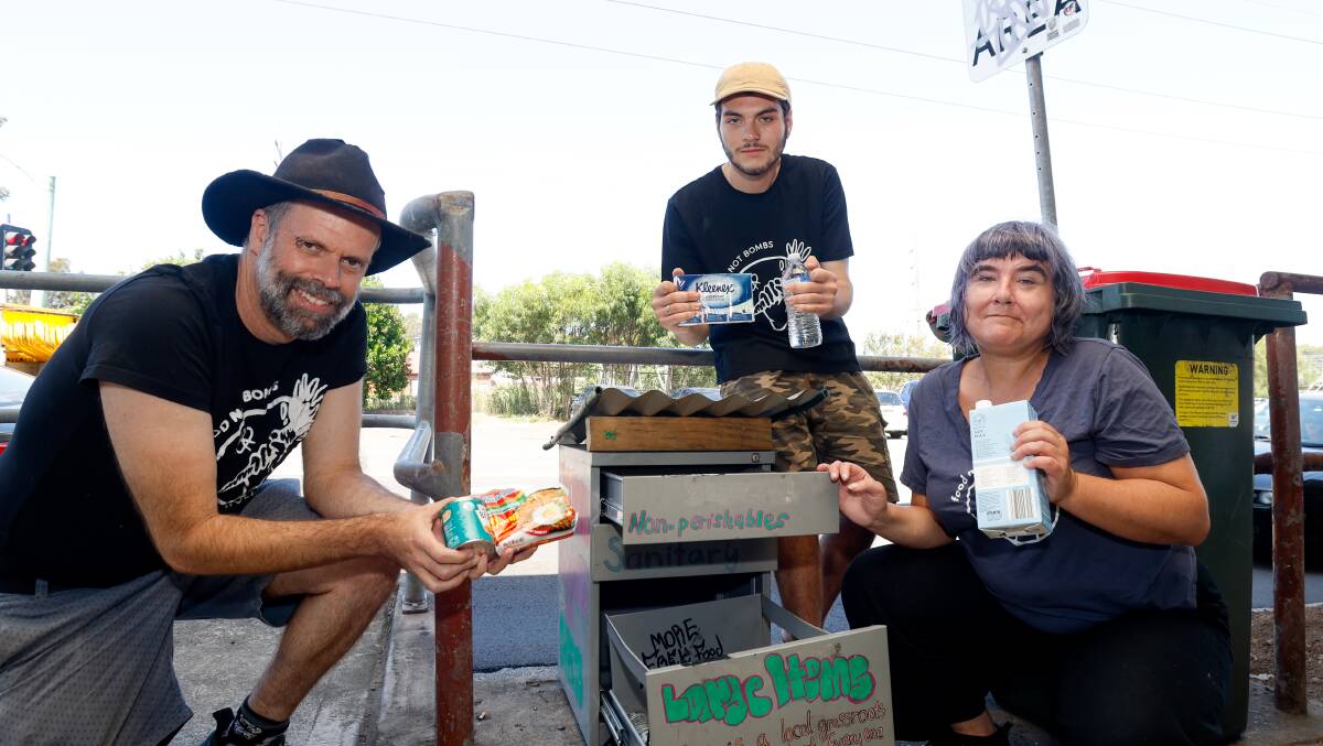 Simon Frew, Zach Jones and Jade Pegler at the free community pantry at Coniston station, set up by their group Food not Bombs. Picture by Anna Warr