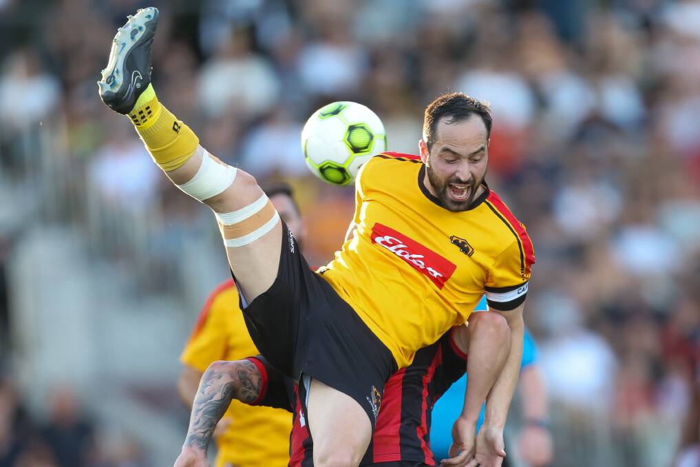 September 17. Coniston's Lukas Stergiou leaps for the ball during the IPL football grand final between Cringila and Coniston at WIN Stadium.