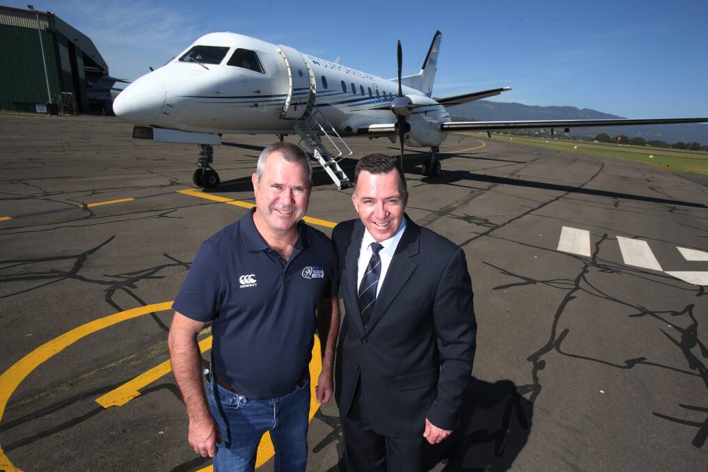 Kiama Sevens tournament director Mark Bryant and Fly Corporate sales manager Geoff Woodham at Illawarra Regional Airport.  Photo: Robert Peat
