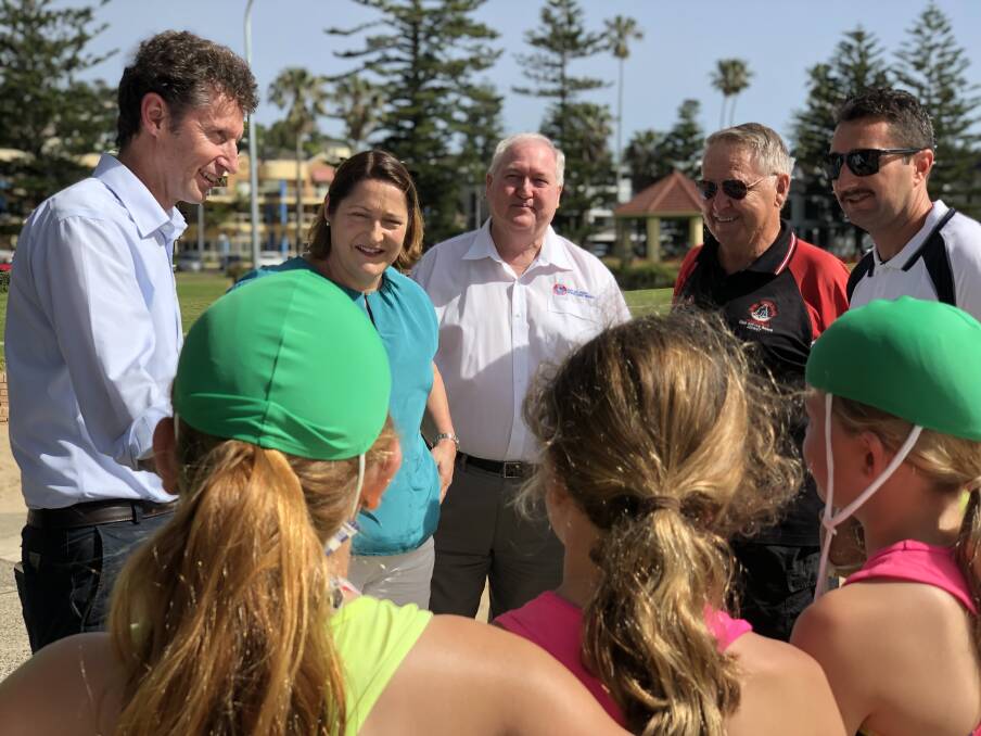 Whitlam MP Stephen Jones and Labor candidate for Gilmore Fiona Phillips chat with members of the Kiama Surf Club. 