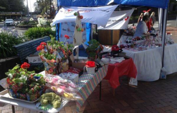 Kiama Red Cross set up their annual Christmas stall on the corner of Terralong and Shoalhaven Streets on Saturday morning.