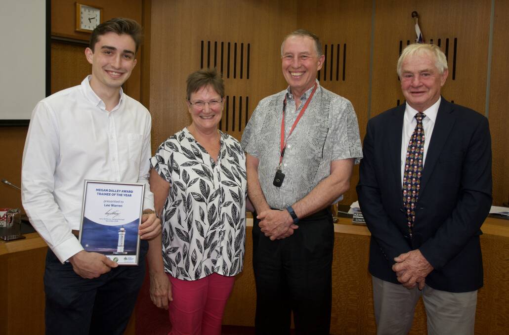Lee being presented with the award by Mayor Mark Honey and Megan's parents Robyn and Andrew.