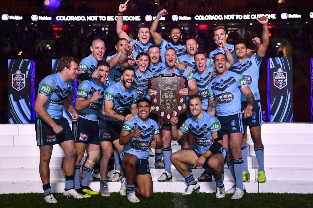 WINNERS: Tariq Sims (back row, third from right) and his NSW team mates celebrate winning the 2018 State of Origin series. Photo: Darren England