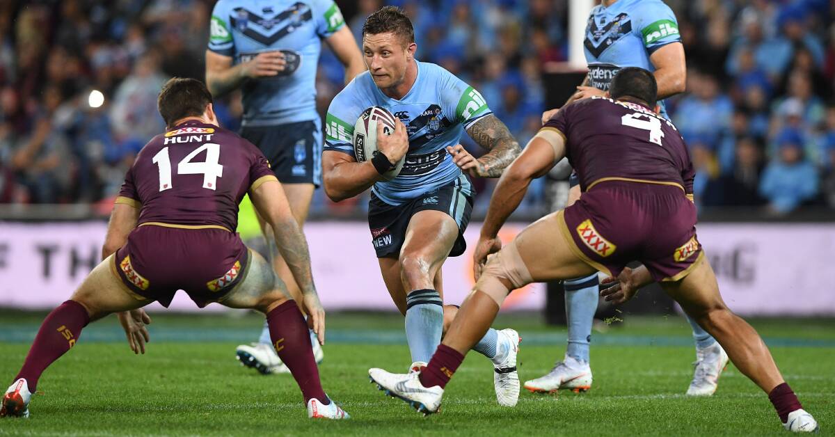BLEED BLUE: Gerringong's Tariq Sims takes a hit-up during Wednesday's State of Origin match at Suncorp Stadium. Photo: Dave Hunt