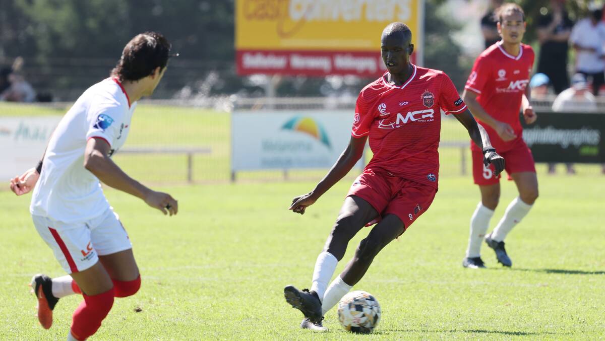Wolves player Samuel Riak drives the ball forward during a recent game against St George City. Picture by Sylvia Liber