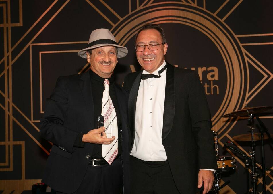 Pharmacy of The Year: Tom Perri (left) owner of Cincotta Discount Chemist Warrawong accepting the Award recently from Ventura Health CEO Mario Capanna. The Ventura Health awards had a stylish Great Gatsby theme.
