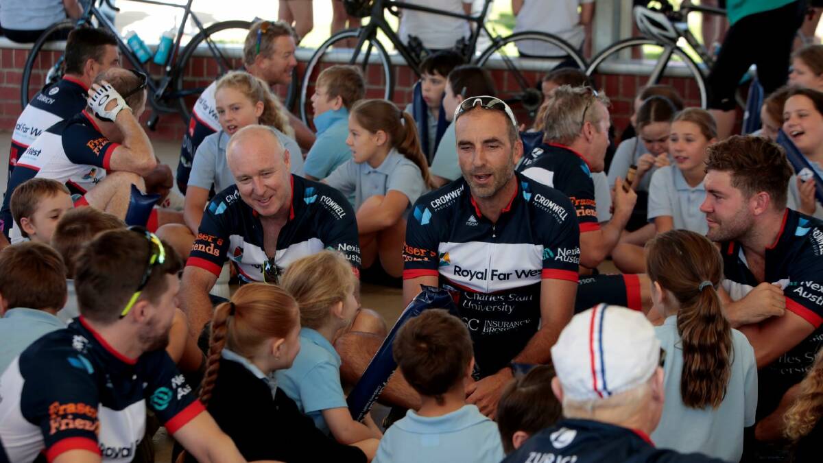 Cyclists in the Ride for Country Kids talk to the pupils at Coolamon Central School.