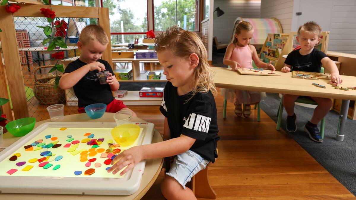 Hudson Brown, far left, and Wade Welland check out what's in store at Mt Warrigal Public School pre-school. Pictured at the next table are their twins Olivia Welland and Lennox Brown. Picture by Adam McLean