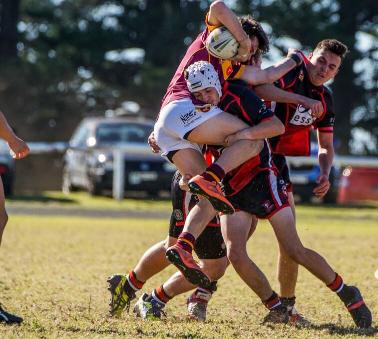 Kiama Knights hooker Kade Roberts (white helmet) tackles a Shellharbour Sharks player earlier in the season. Picture: SPORTS FOCUS PHOTOGRAPHY