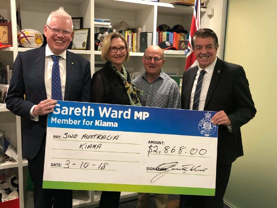 Kiama MP Gareth Ward and NSW Minister Ray Williams (right) presenting $2,868 in funding to Mr Richard Norris, Group Leader of Sing Australia Kiama and Maree from Sing Australia Kiama, to go towards the purchase of some new equipment. Picture: Contributed