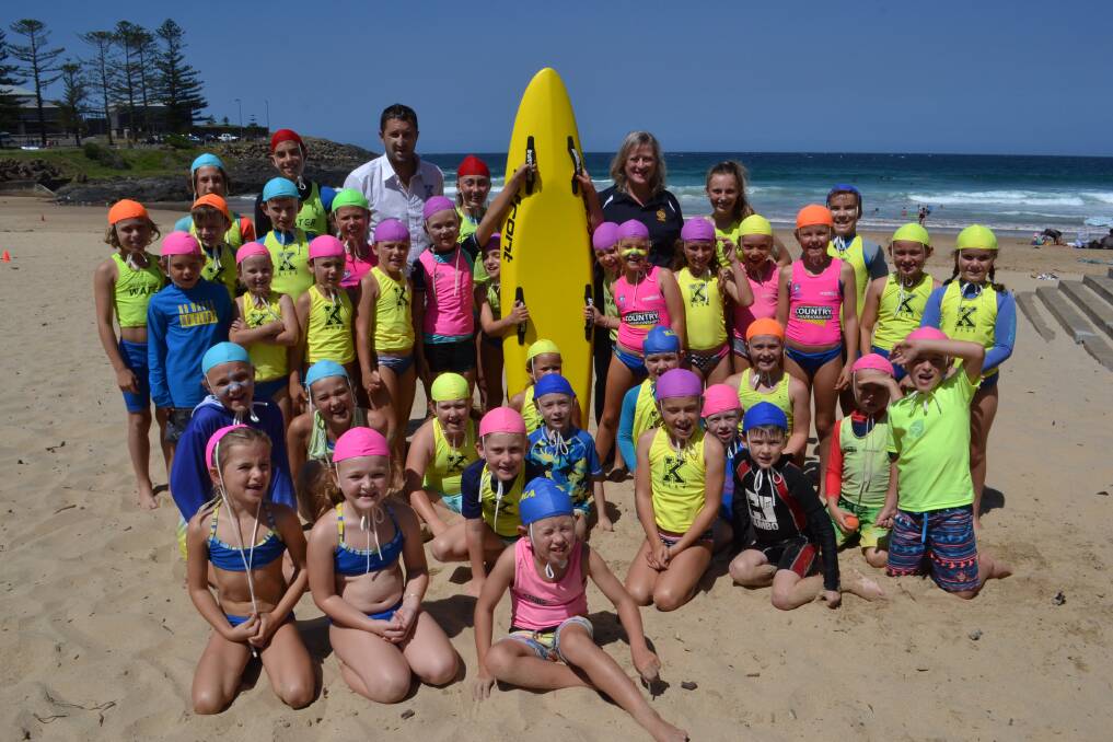 NEW BOARD: Kiama SLSC inherits a new nipper board for their kids, thanks to the generosity of Carol Johnston. Nippers were all smiles on Saturday. Picture: Rebecca Fist