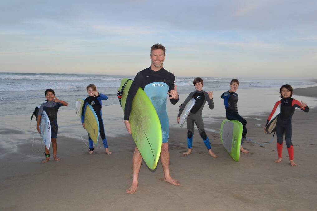 RUSTY'S CREW: Tristan Gale, Jonah Andrews, instructor Rusty Moran, Oli Shepherd, Oliver West and Sam Le at Berry Beach on Thursday. They hope to be surfing in safer waters by September. Picture: Rebecca Fist