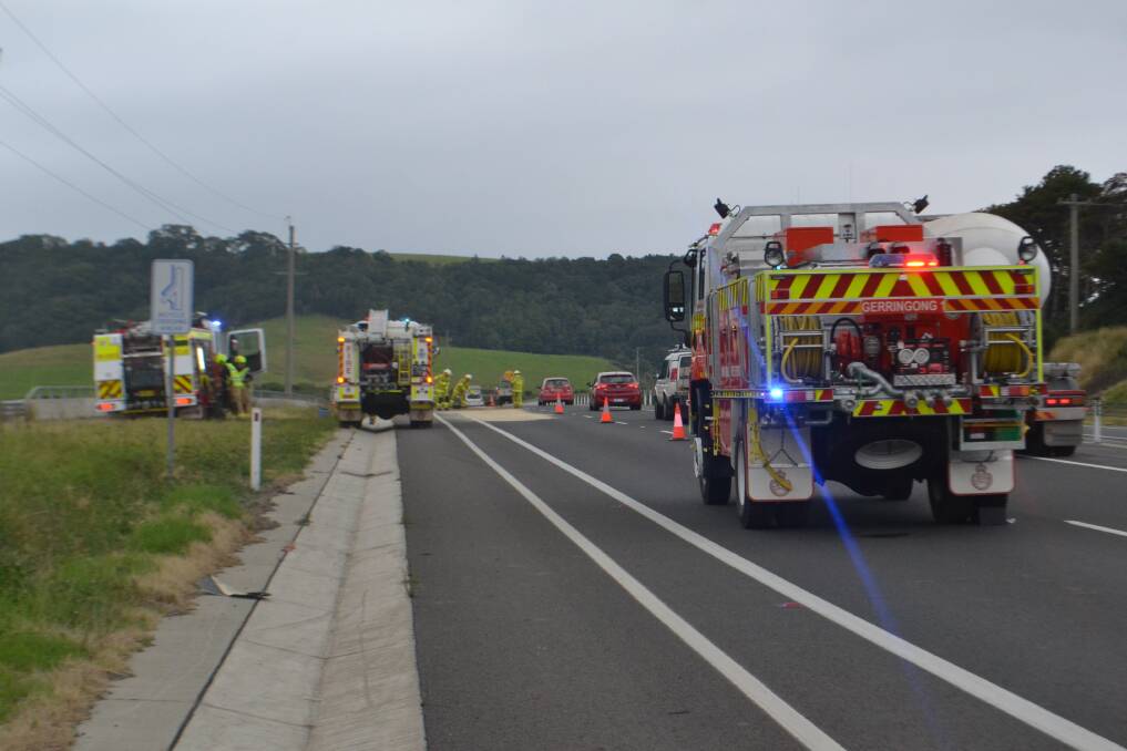Gerringong RFS crews mop up oil spilled in an accident on the Princes Hwy, Gerringong, on Saturday afternoon.