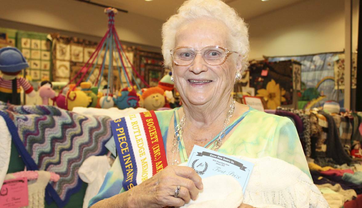 Former Kiama Show secretary Nancy Waters proudly shows off her winning entry in the knitting section of the 2013 Kiama show where she won her first ever ribbon. Picture: DAVID HALL