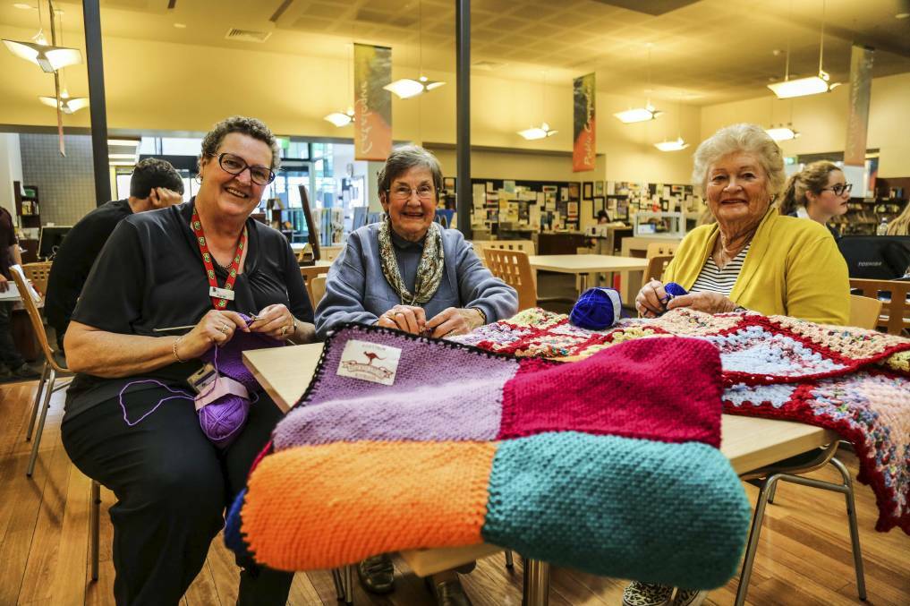 Kiama Librarian Karan Oldershaw, Katherine Leverett and Margaret Beatty knitting for Wrap With Love Charity in 2014. Picture: GEORGIA MATTS