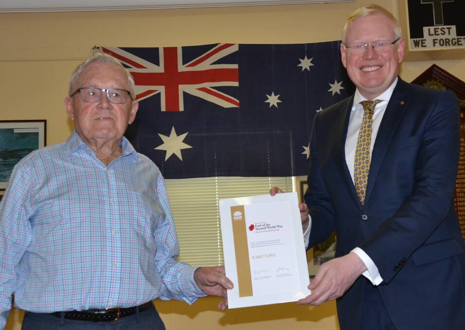 CONGRATS: Kiama MP Gareth Ward congratulates and presents Gerringong RSL member Bill Popple with a certificate marking the 75th anniversary of the end of World War II and marking his service.
