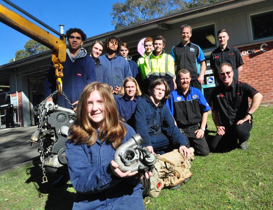 TAFE NSW Nowra TVET students Saphyre Bunyan, Kuyan Wellington, Dre Howlett, Locky Weekhout, Ethen Robertson, Dawson Hollands, Blake Elson, Jesse Bell and Robert Leighton and automotive head teacher Nathan Malmborg, Allan Byrne (Mobile Farm Service) and MotAtec directors Greg Lynch and James Clarke with the donated engine and parts.