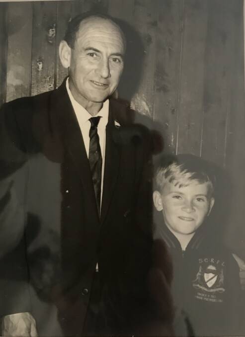 Kiama Knights under 9 premiership player James Regan proudly shows off his blazer with his father Neville.
