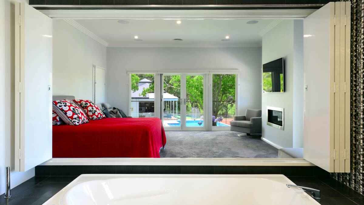 The main bedroom opens to views of the pool. Photo: Supplied