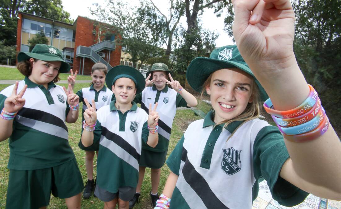 Albion Park Public School students Emily Longhurst, Kelsey Harrison, Koby Clark, Kiara Watson and Charlotte Petch with wristbands promoting National Day of Action Against Bullying & Violence. Picture: Adam McLean