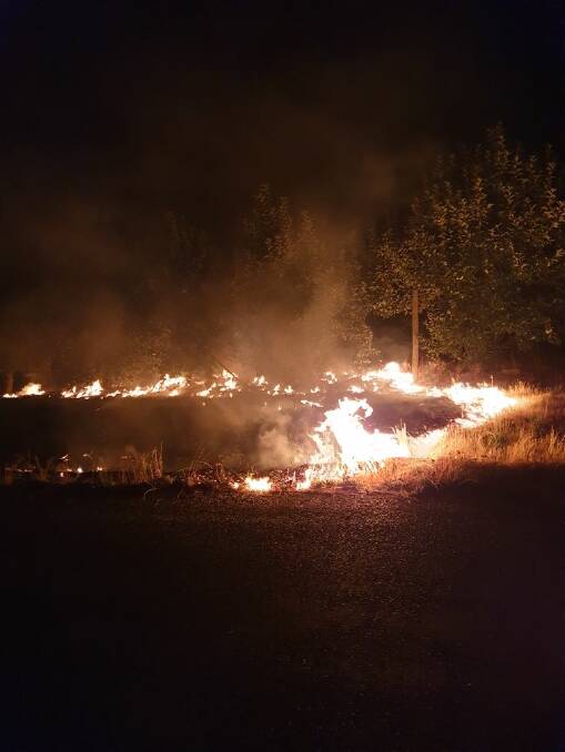 A grass fire burns in Batlow on Saturday. Picture: Matthew Rudd