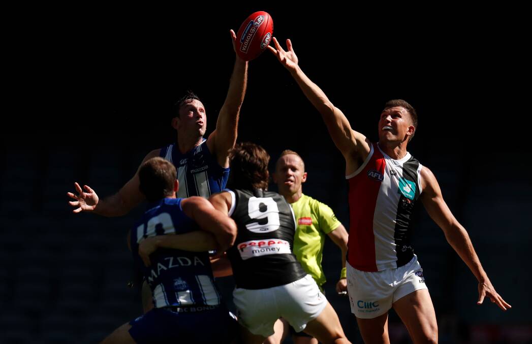 North Melbourne Kangaroos' Todd Goldstein and St Kilda Saints' Rowan Marshall compete in a ruck contest during the 2020 AFL Round 01 match at Marvel Stadium in March. Reassurance from the announcement of a financial lifeline for the league has been drowned out by "media games" fuelling idle speculations and "death-riding" clubs' futures. Photo: Michael Willson/AFL Photos via Getty Images.
