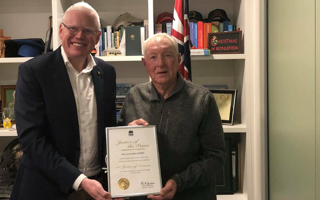 Member for Kiama Gareth Ward presents Kiama JP Bill Gilbert with a commendation for 50 years of service.