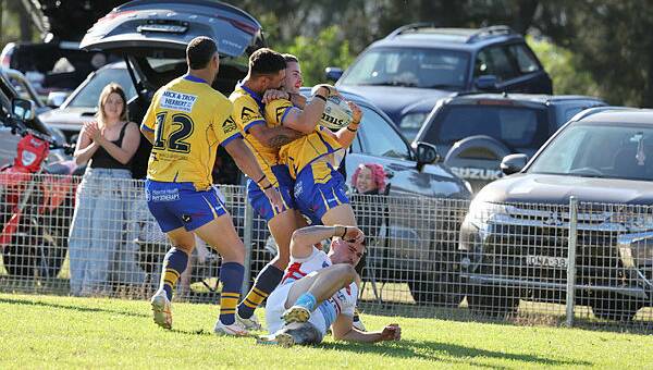 Warilla Lake South Gorillas players hug Dane Nelson after the winger scored one of his three tries against Milton-Ulladulla Bulldogs at Cec Glenholmes Oval on Sunday, April 21, 2024. Picture by Robert Peet
