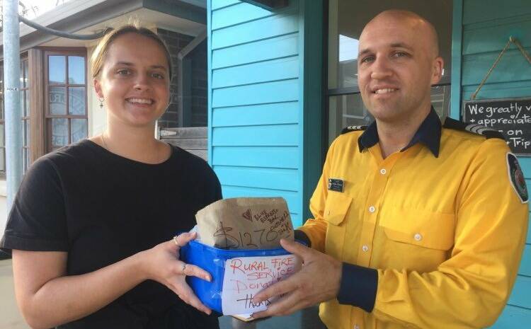 BIG THANKS: Zara Davies hands over a donation of more that $1000 to Gerringong RFS brigade Captain Andrew Downes on Monday, March 2.