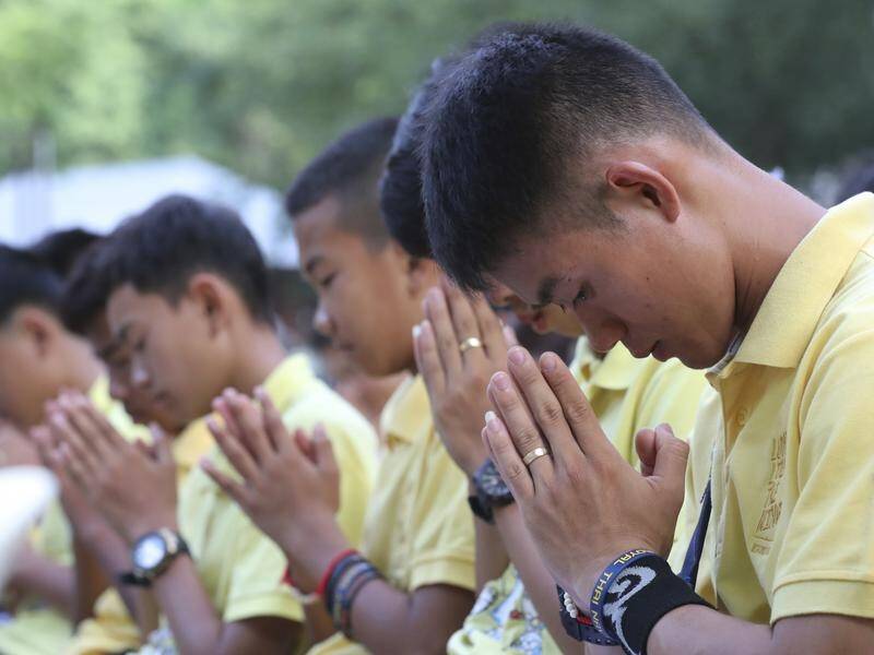 The Wild Boars soccer team who were rescued from a flooded cave pray on their one-year anniversary.