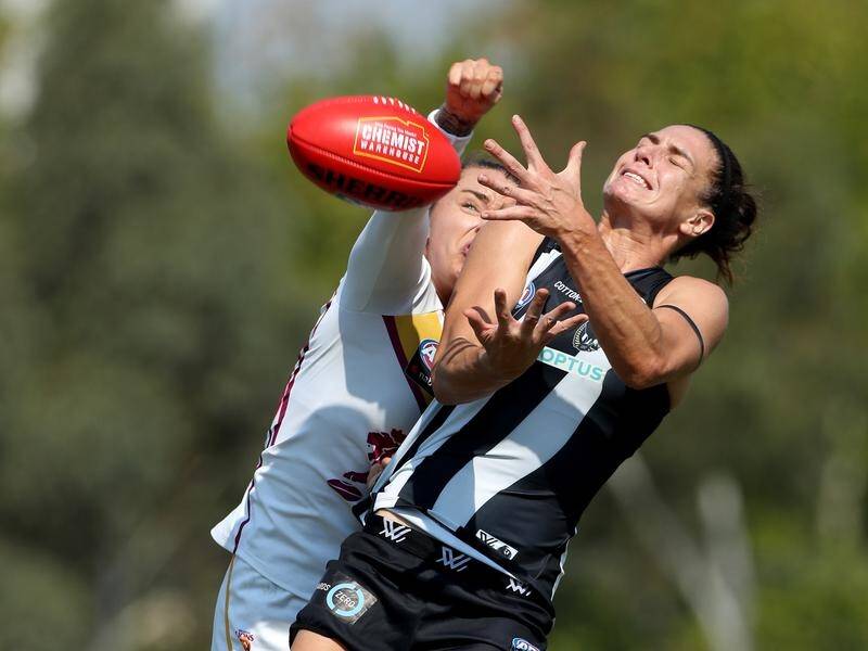 Ash Brazill of the Magpies competes with Jess Wuetschner of the Lions during their AFLW clash.