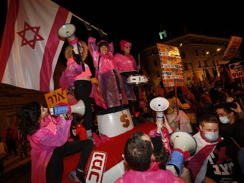 Pink-clad Israelis protested outside the prime minister's residence and private home.