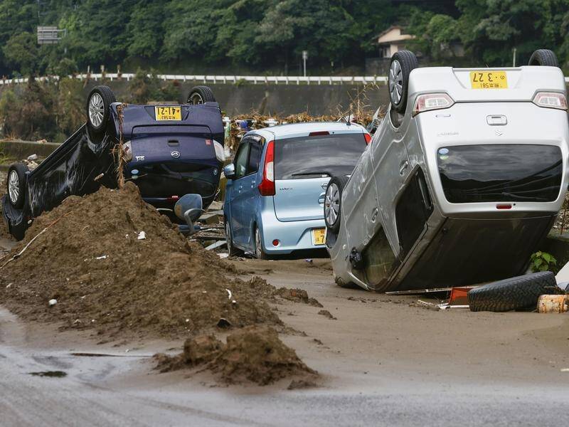 Prime Minister Shinzo Abe has visited southwest Japan where flooding has killed at least 68 people.
