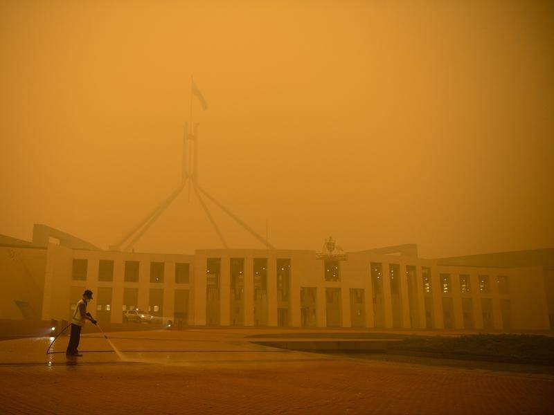 Smoke haze from bushfires has enveloped Canberra landmarks including Parliament House.