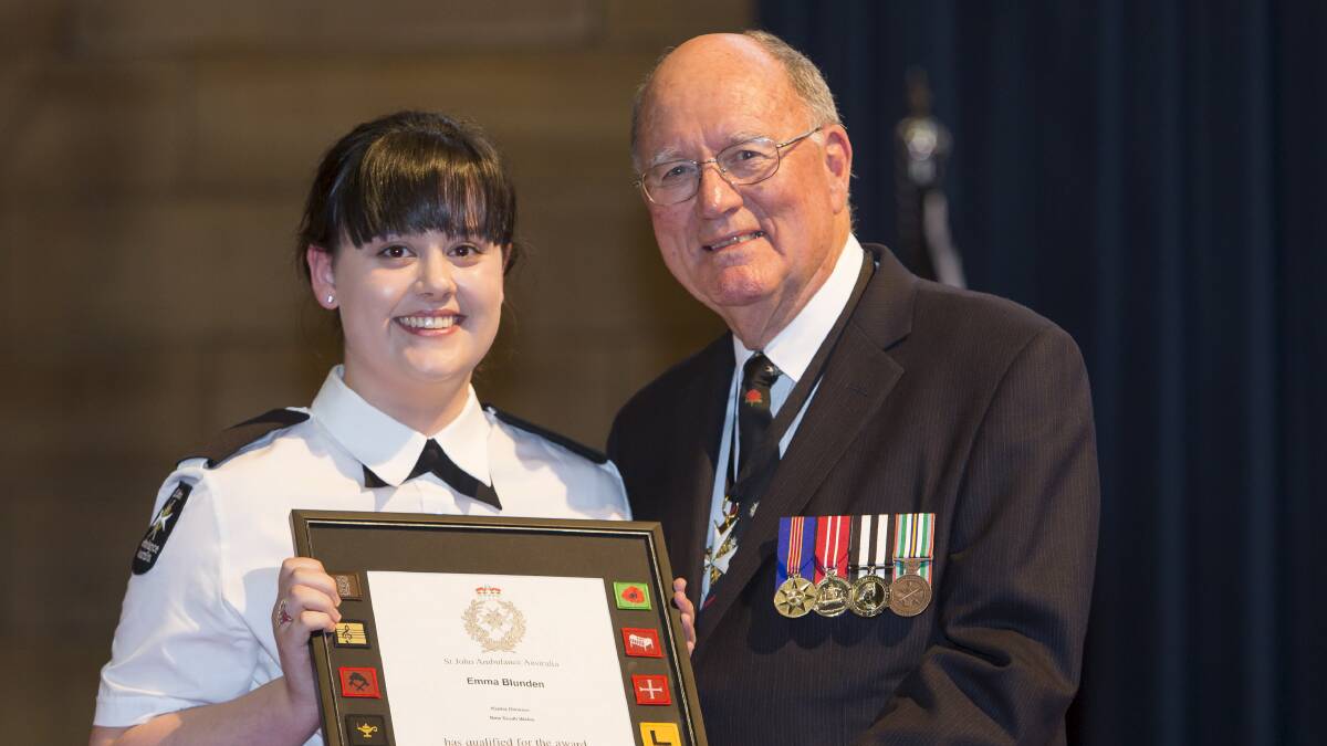Emma Blunden is presented with her award by Dr Neil Conn, Lord Prior of The Order of St John.  