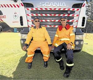 Warren Robinson and Peter Robinson of Bulli RFS with the water truck. Picture: Dylan Robinson